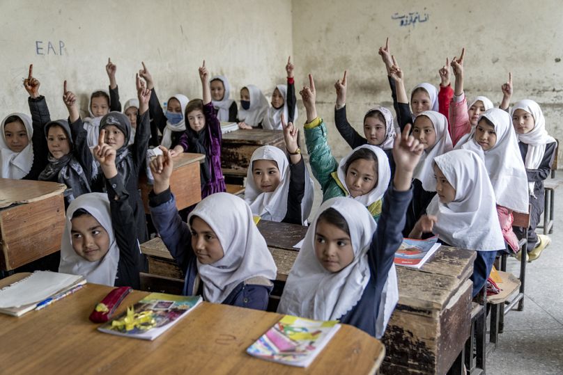 Afghan school girls in their classroom on the first day of the new school year, in Kabul.