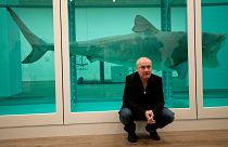 Damien Hirst beside the 1991 piece "The Physical Impossibility of Death in the Mind of Someone Living"