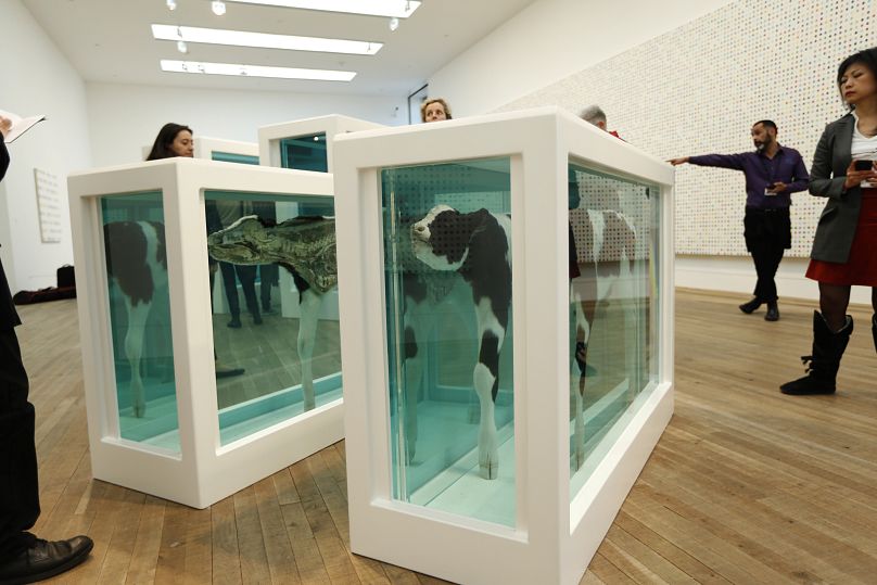 People look at part of the British artist Damien Hirst's 2007 exhibition copy piece of the 1993 original "Mother and Child Divided"