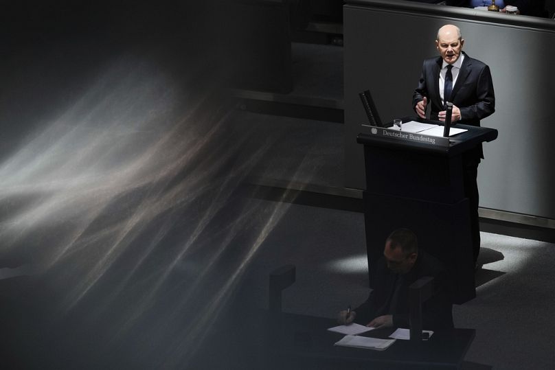 German Chancellor Olaf Scholz delivers a speech at the German parliament Bundestag in Berlin ahead of a EU summit.