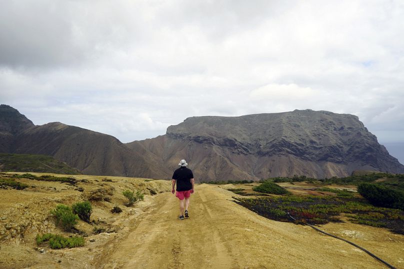 A hiker walks the Cox's Battery trail on the island of St Helena