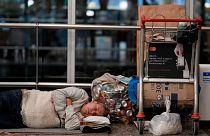 A homeless man sleeps near his belongings at the Jorge Newbery international airport, commonly known as Aeroparque, in Buenos Aires, Argentina, Thursday, April 6, 2023.