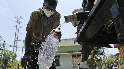 Man collects water from a pump