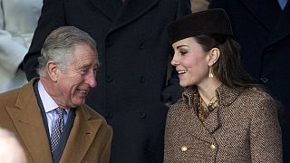 FILE - Charles chats with his daughter-in-law Kate in Sandringham, England, Thursday, Dec. 25, 2014.