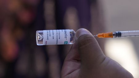 FILE - A healthcare worker prepares a dose of the AstraZeneca COVID-19 vaccine during a door-to-door vaccination campaign, in El Alto, Bolivia.