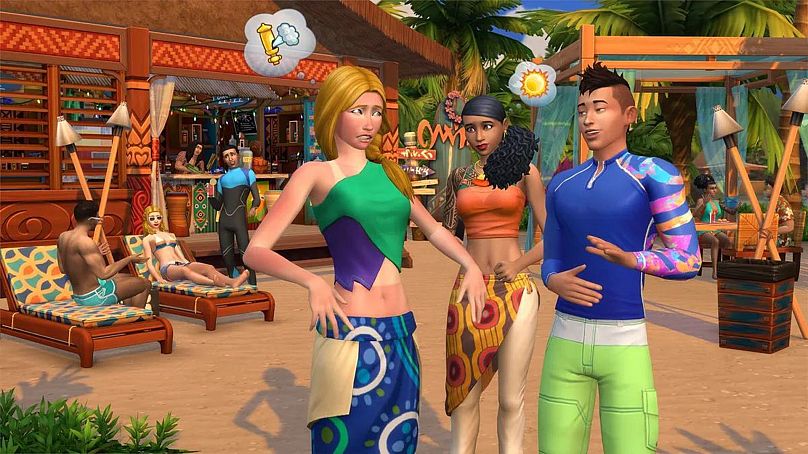 Photo shows three Sims speaking on a beach setting