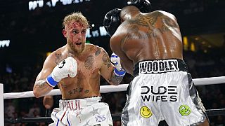Jake Paul, left, punches Tyron Woodley during the second round of a Cruiserweight fight Sunday, Dec. 19, 2021,