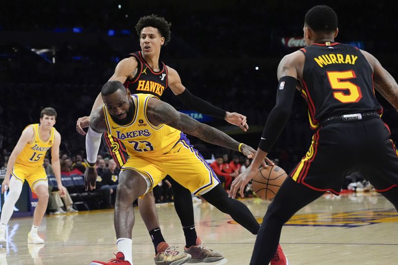 Los Angeles Lakers' LeBron James (23) drives with the ball against Atlanta Hawks' Dejountee Murray (5) during the first half of an NBA game in Los Angeles, March 18, 2024