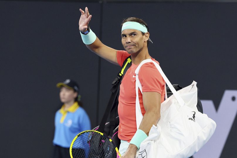 Nadal waves to the crowd at his doubles match against Australia's Max Purcell and Jordan Thompson during the Brisbane International tennis tournament in Brisbane, 2023.