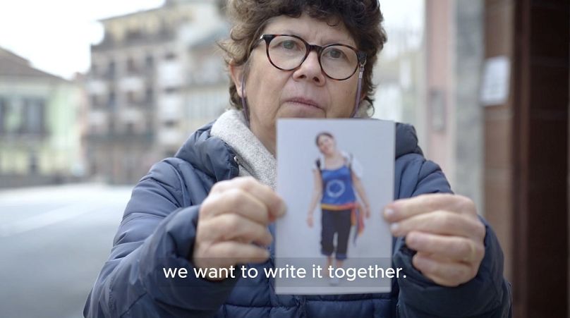 Angela Bedoni holds a photo of her daughter, in an emotional video appeal asking the government to pause the reform and re-write it with road victims' families.