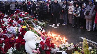 People gather to lay flowers and light candles next to the Crocus City Hall, on the western edge of Moscow, Russia, Saturday, 23 March, 2024. 