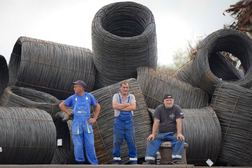 Metal scrapyard workers in Braila, Romania, August 2021