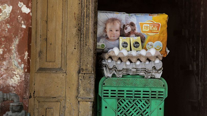 تخم مرغ، سیگار برگ و پوشک بچه برای فروش در ورودی یک خانه، در هاوانا، کوبا.