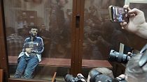 Dalerdzhon Mirzoyev, a suspect in the Crocus City Hall shooting on Friday sits in a glass cage in the Basmanny District Court in Moscow, Russia, Sunday, March 24, 2024.