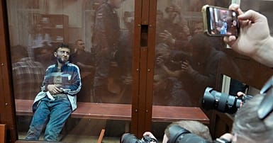 Four bruised and bloodied men charged over Moscow concert attack ...