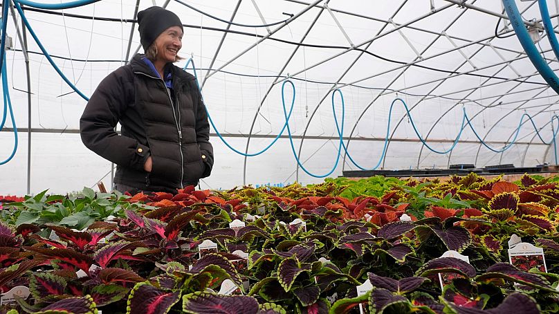 Katy Rogers, the farm manager at Teter Organic Farm and Retreat Center, stands inside of greenhouse at the facility, 21 March 2024, in Noblesville, Indiana.