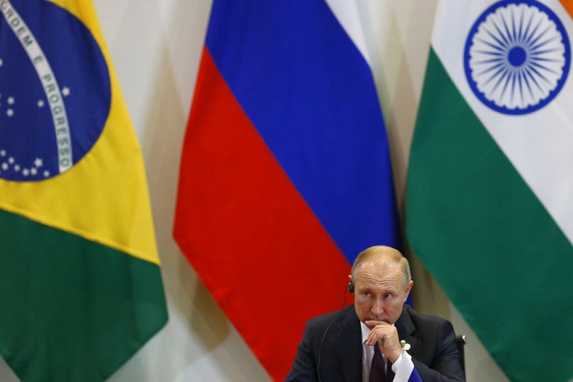 Russia's President Vladimir Putin listens during a BRICS meeting in Brasilia, November 2019