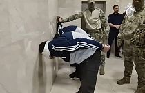 Photo taken from video released by Investigative Committee of Russia, shows suspects in the Crocus City Hall shooting