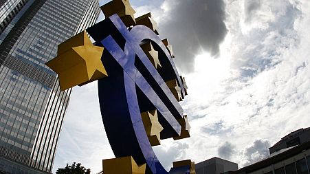 In this July 31, 2012 file photo the euro sculpture stands in front of the headquarters of the European Central Bank, ECB, in Frankfurt, Germany. 