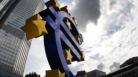 FILE - In this July 31, 2012 file photo the euro sculpture stands in front of the headquarters of the European Central Bank, ECB, in Frankfurt