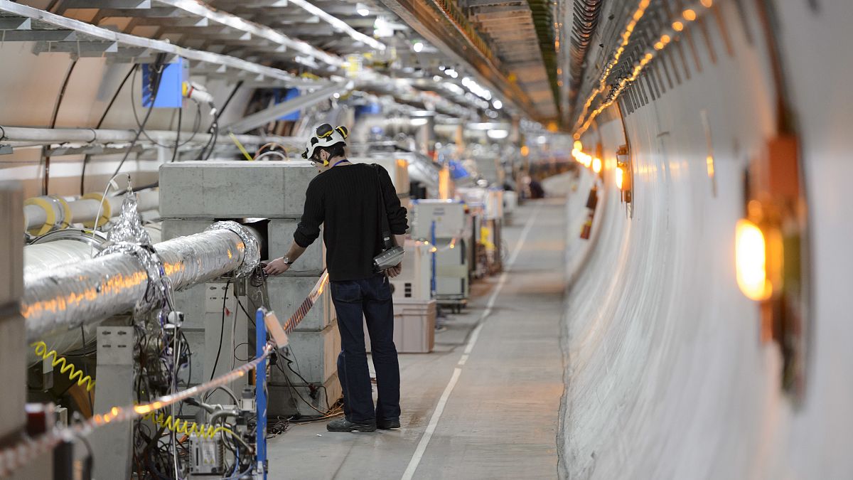 A technician works in the LHC (Large Hadron Collider) tunnel of CERN, 2016.
