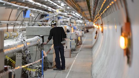 A technician works in the LHC (Large Hadron Collider) tunnel of CERN, 2016.