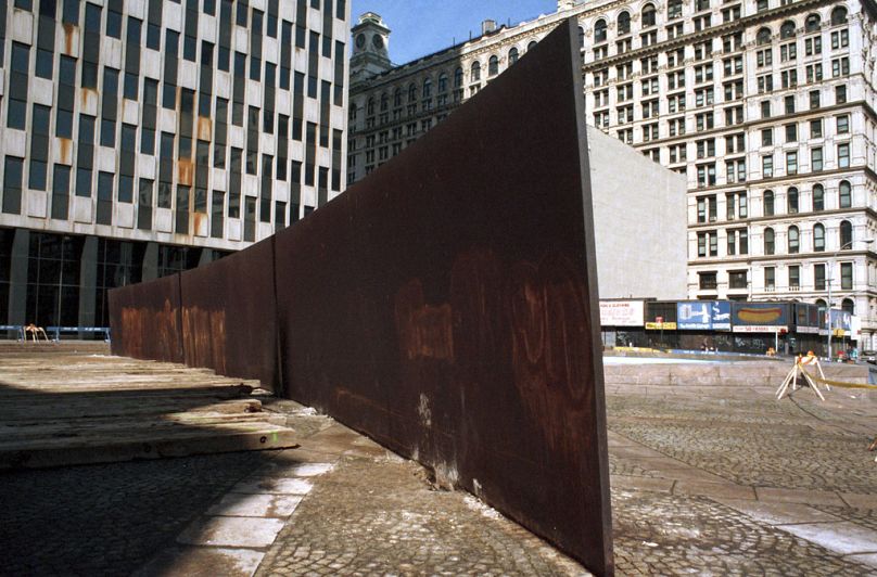 "Tilted Arc," a 12-foot-high, curving, inclined wall of rusting steel by famed American sculptor Richard Serra, awaits removal, March 11, 1989, New York.