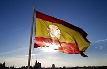A Spanish flag flies above part of the Madrid skyline, Monday July 2, 2012.