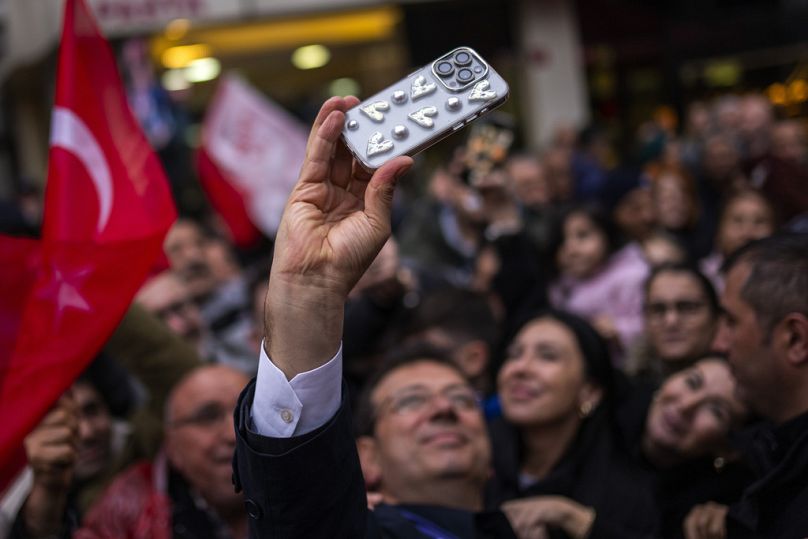 Mayor and CHP candidate for Istanbul Ekrem Imamoglu takes a photograph with supporters during a campaign rally, in Istanbul, March 2024