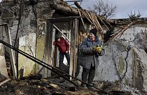 Inna, 71, holds food items outside her house which was destroyed by a Russian drone attack in Zaporizhzhia, Ukraine, on Thursday, March 28th 2024