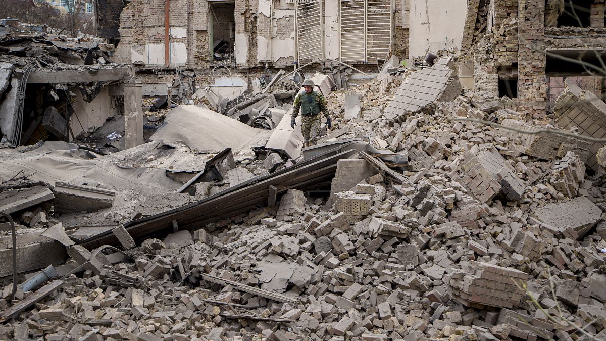 جندي أوكراني يتفقد الأضرار التي لحقت بمبنى في منطقة بيشيرسكي، بعد هجوم جوي روسي في كييف