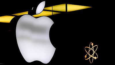 The Apple logo is illuminated at a store in Munich, Germany, Monday, November 13, 2023