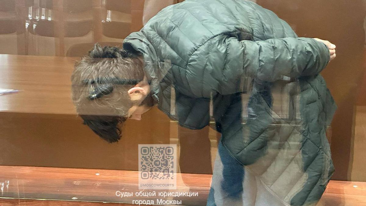 Lutfulloi Nazrimad, a suspect in the Crocus City Hall shooting, stands in a glass cage in the Basmanny District Court in Moscow, Russia.