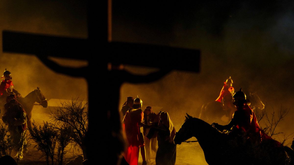 Faithful take part in a Way of the Cross reenactment as part of Holy Week celebrations, in Colina, Chile, Friday, March 29, 2024
