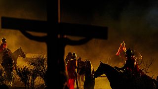 Faithful take part in a Way of the Cross reenactment as part of Holy Week celebrations, in Colina, Chile, Friday, March 29, 2024