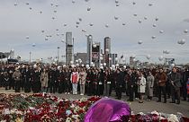 A group of ambassadors of foreign diplomatic missions attend a laying ceremony at a makeshift memorial in front of the Crocus City Hall 
