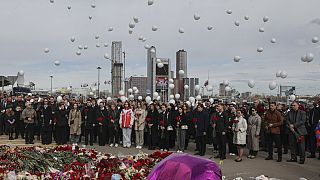 A group of ambassadors of foreign diplomatic missions attend a laying ceremony at a makeshift memorial in front of the Crocus City Hall 