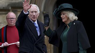 Britain's King Charles III, center, and Queen Camilla wave as they arrive to attend the Easter Matins Service at St. George's Chapel, Windsor