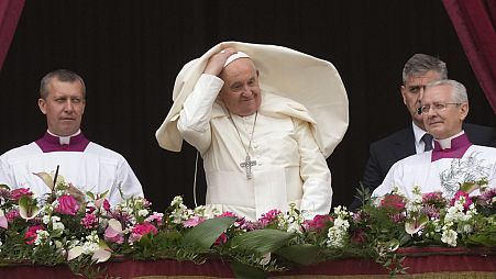 Pope Francis smiles from the central balcony of the St. Peter's Basilica prior to the 'Urbi et Orbi' (To the city and to the world) blessing