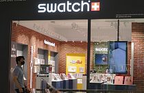 A man walk pass Swatch outlet at a shopping mall in Putrajaya, Malaysia, Thursday, Aug. 10, 2023.
