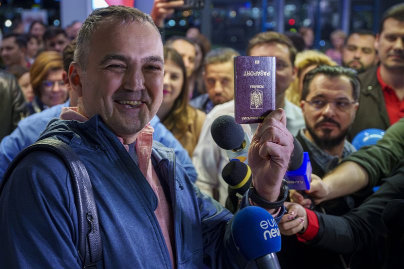 Passenger shows his passport at the Henri Coanda International Airport in Otopeni, near Bucharest, Romania, Sunday, March 31, 2024
