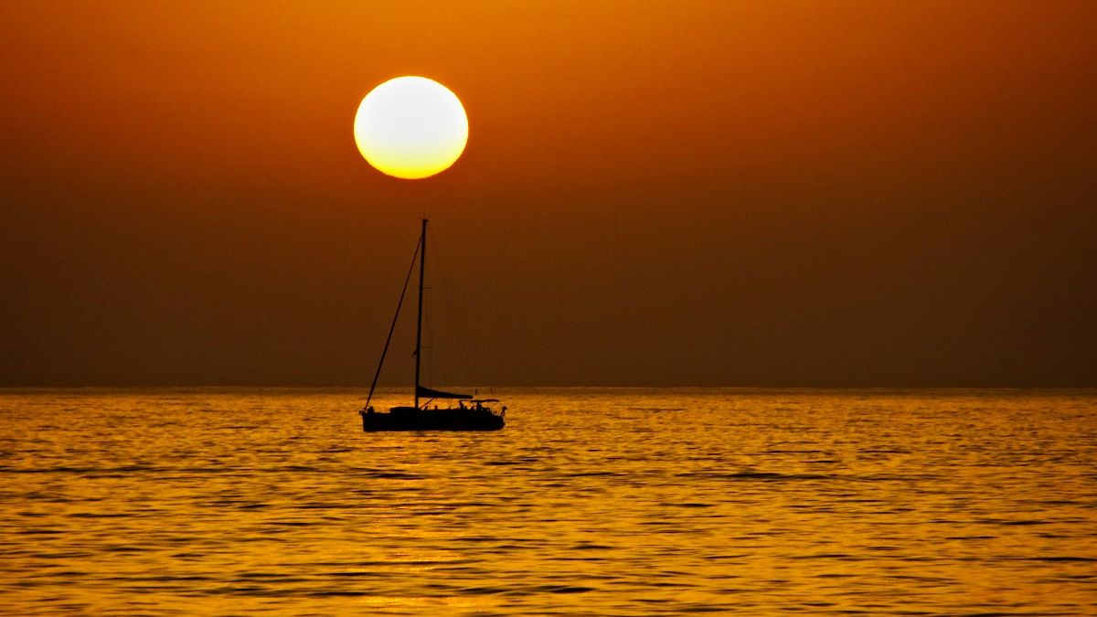 Sunset lover: A boat sails near Stromboli, Aeolian islands