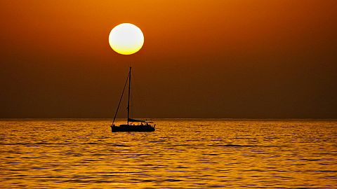 Sunset lover: A boat sails near Stromboli, Aeolian islands