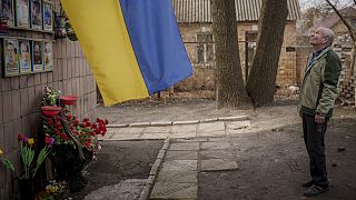 Oleksandr Turovskyi takes a moment at a memorial on the lot where his son was found in Bucha, Ukraine, Saturday, March 30, 2024.