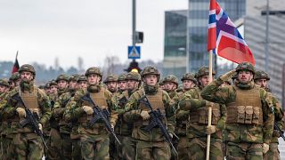 Norwegian soldiers march during a military parade ceremony.