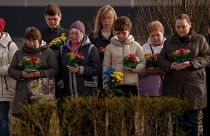 Relatives of those killed during the Russian occupation attend a commemoration of the victims at a cemetery in Bucha, Ukraine, Sunday, March 31, 2024.