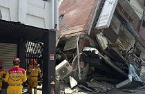 In this photo released by the National Fire Agency, members of a search and rescue team prepare outside a leaning building in the aftermath of an earthquake in Hualien.