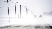 Wind-driven snow blowing east to west rolls over Dee-Mac Road between Washington and Eureka, Ill., on Wednesday, Jan. 5, 2022.