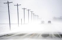 Wind-driven snow blowing east to west rolls over Dee-Mac Road between Washington and Eureka, Ill., on Wednesday, Jan. 5, 2022.