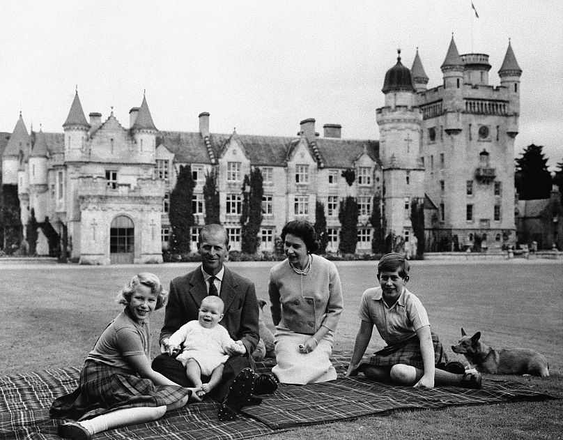1960: Britain's Queen Elizabeth II, Prince Philip and their children, Prince Charles, right, Princess Anne and Prince Andrew, pose for a photo on the lawn of Balmoral Castle